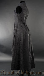 Side view of black brocade women's choker dress showing high low style skirt cut and adjustable back lacing