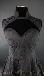 Close up front view of women's black brocade dress showing queen anne style neckline and additional high collar