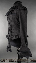 Side view of long sleeved black blouse in brocade fabric with detachable cravat and flared layered sleeve cuffs