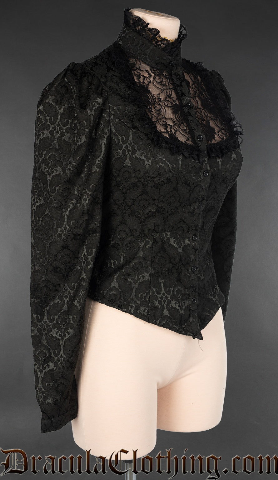 Side view of women's blouse made with black brocade fabric showing puffed shoulders