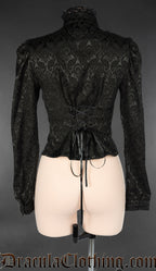 Back view of women's black brocade long sleeve blouse showing adjustable lacing in the back and high neck collar