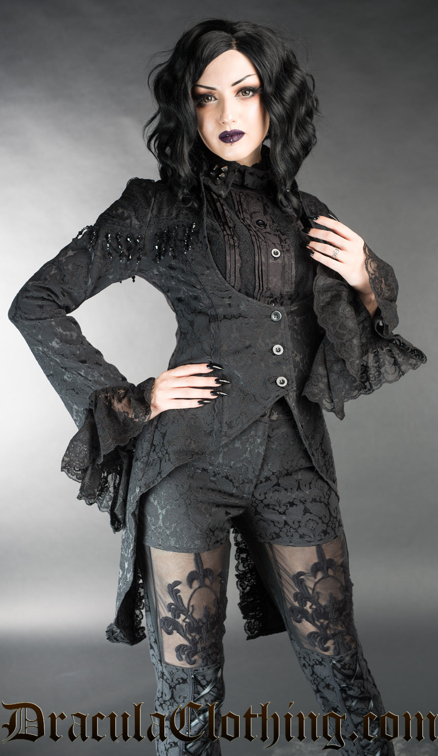 Model wearing women's black brocade tailcoat over black blouse and pants