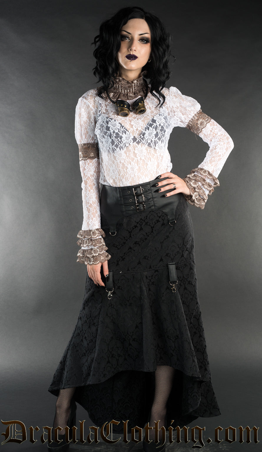 Model wearing white long sleeved lace top with skirt