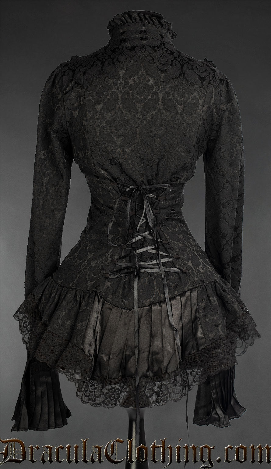 Back view of black brocade blouse showing adjustable corset style lacing and pleated black satin hem with lace trim