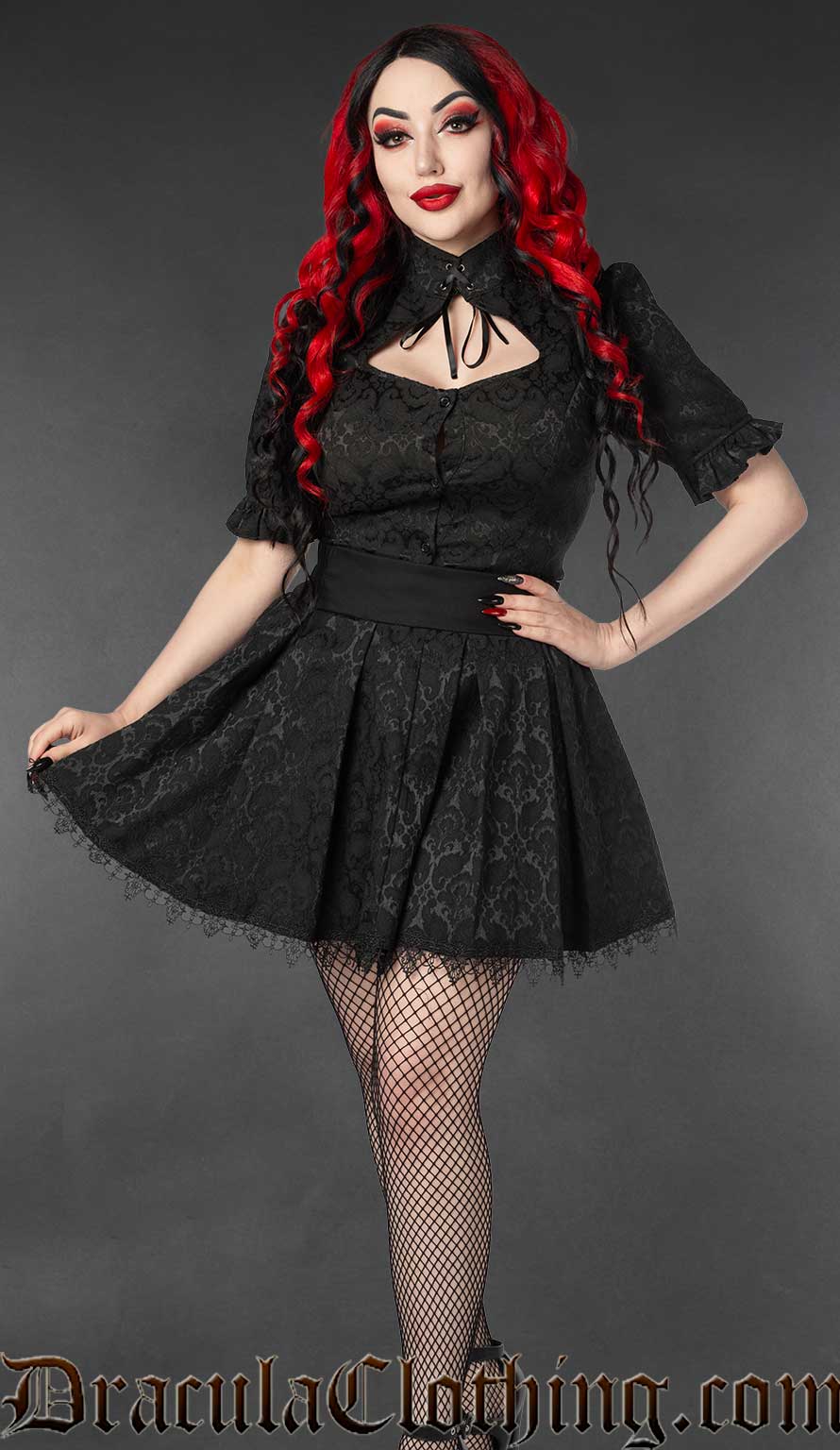 Model wearing black brocade keyhole blouse with matching fabric skirt