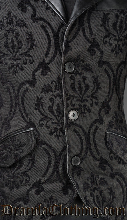 Close up of brocade jacquard fabric showing button down closure and faux leather accents