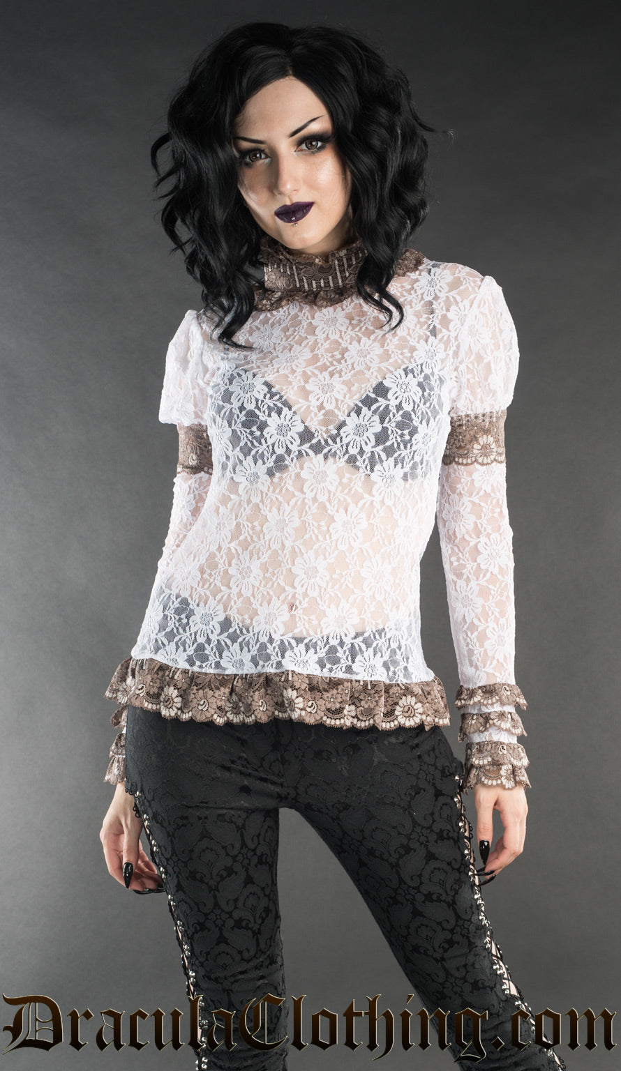 Model wearing women's white sheer lace long sleeve top with brown lace accents