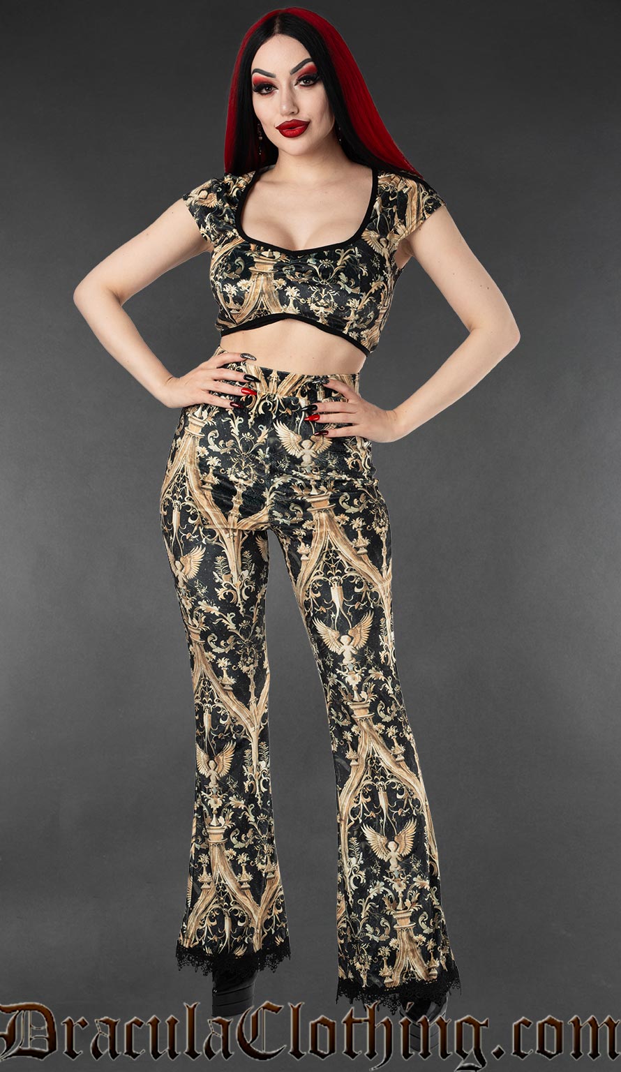Black and gold gothic velvet flare pants with cherub and baroque print worn by a model