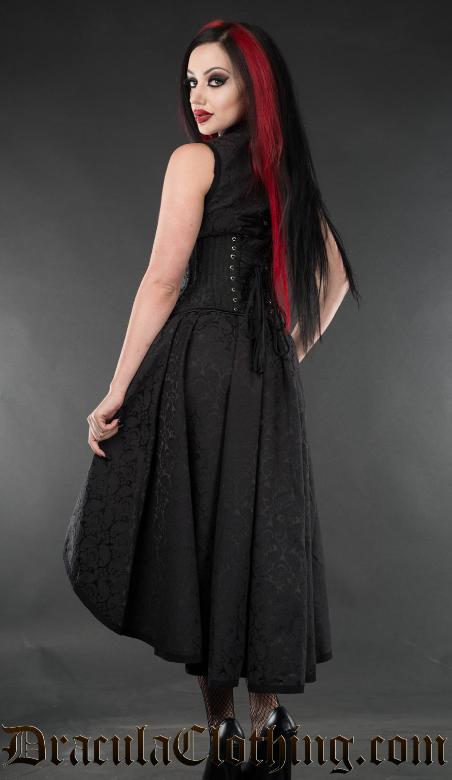 Back view of women's black brocade choker dress worn by a model with additional waist cincher