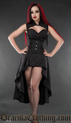 Model wearing women's black brocade high low dress with high neck collar and queen anne neckline 