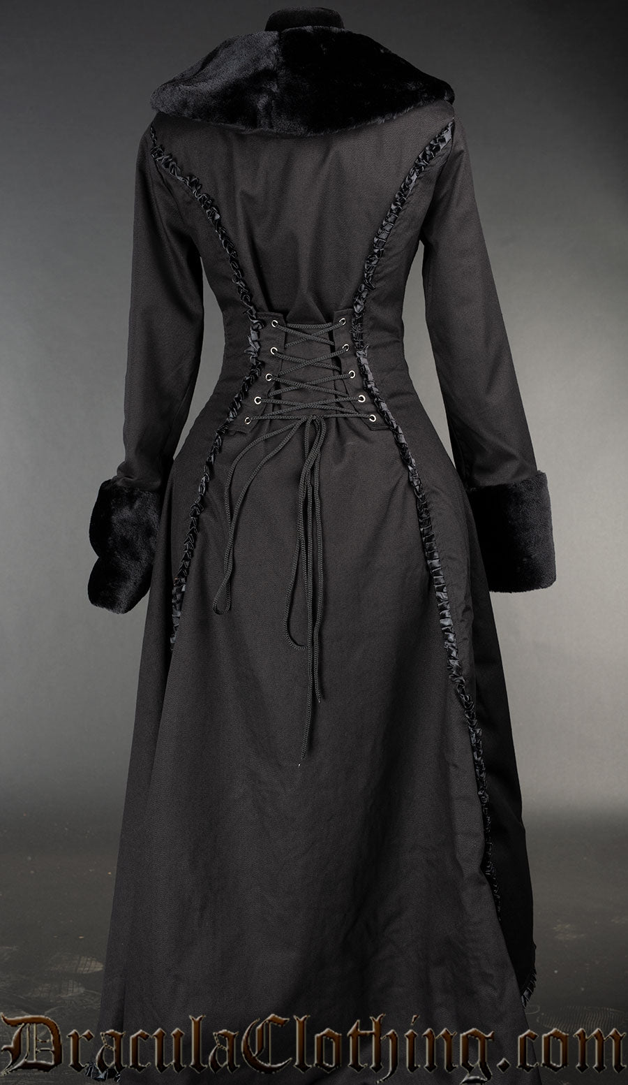 Back of black cotton women's coat showing longer back, frilled satin details and adjustable corset style lacing in the back