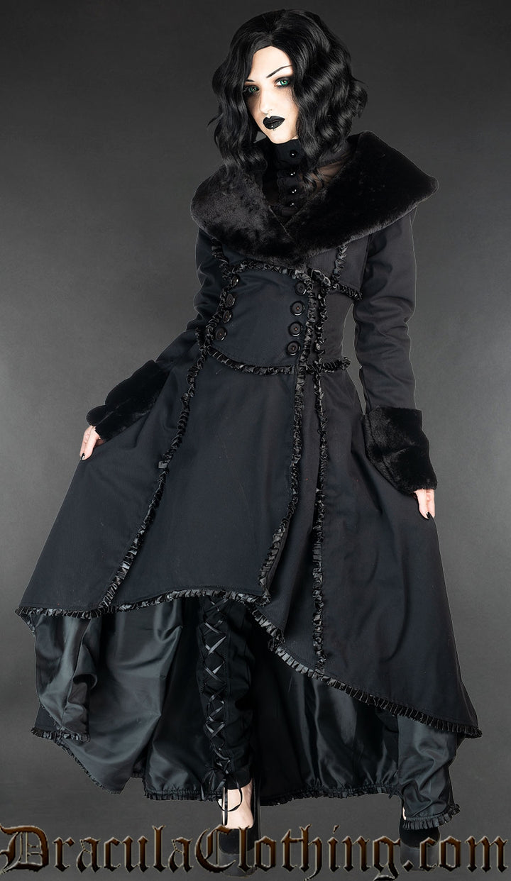 Model wearing black cotton coat with faux fur collar and sleeve cuffs, and satin lining and details
