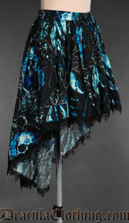 Side view of women's black and blue high low skirt with elasticated waist and pirate skull inspired print