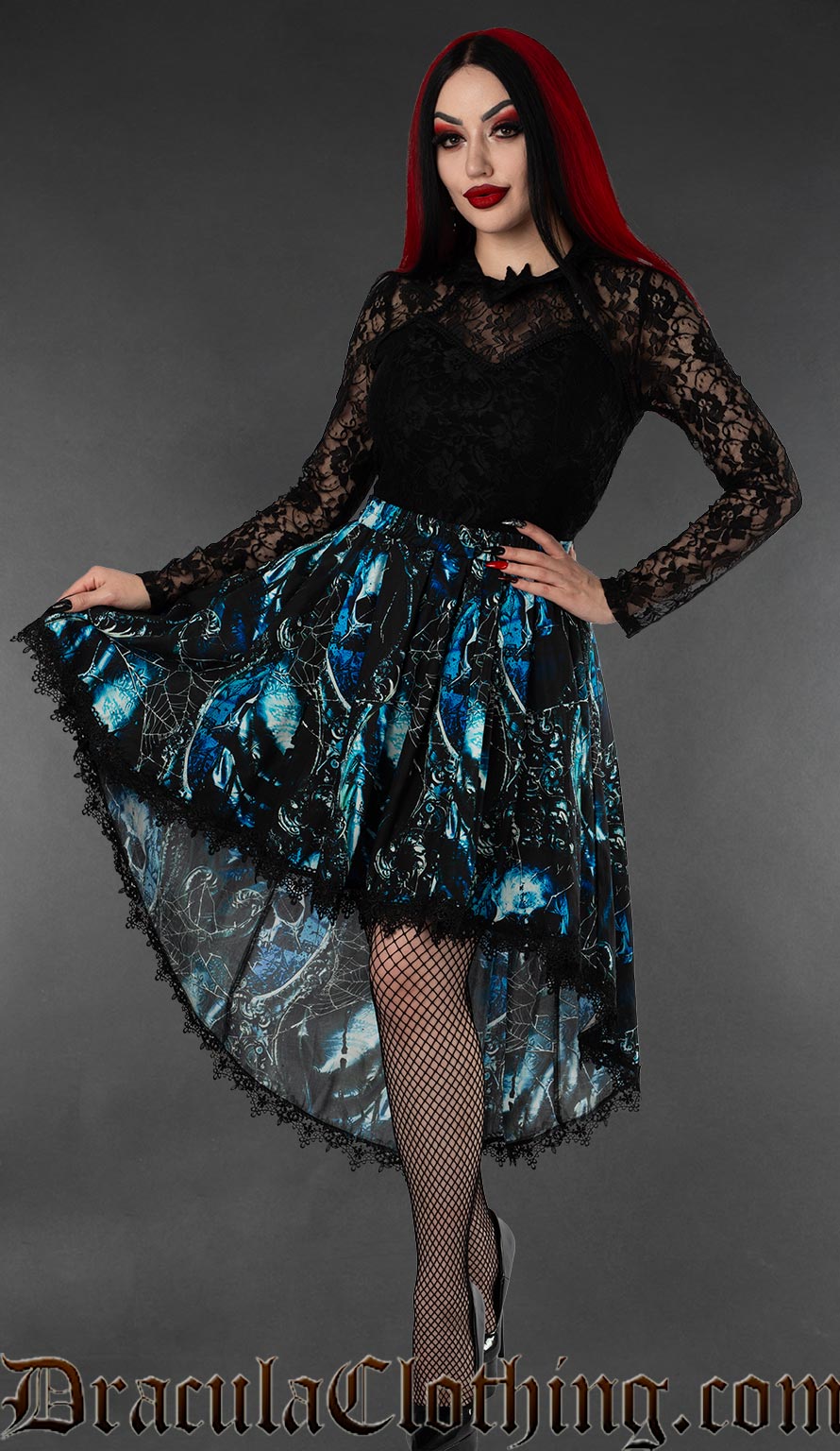 Women's blue and black high low skirt with a pirate skull print and black lace trim worn by a model