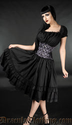 Women's knee length black dress with a square neckline and lace trim in the bust worn with a waist cincher