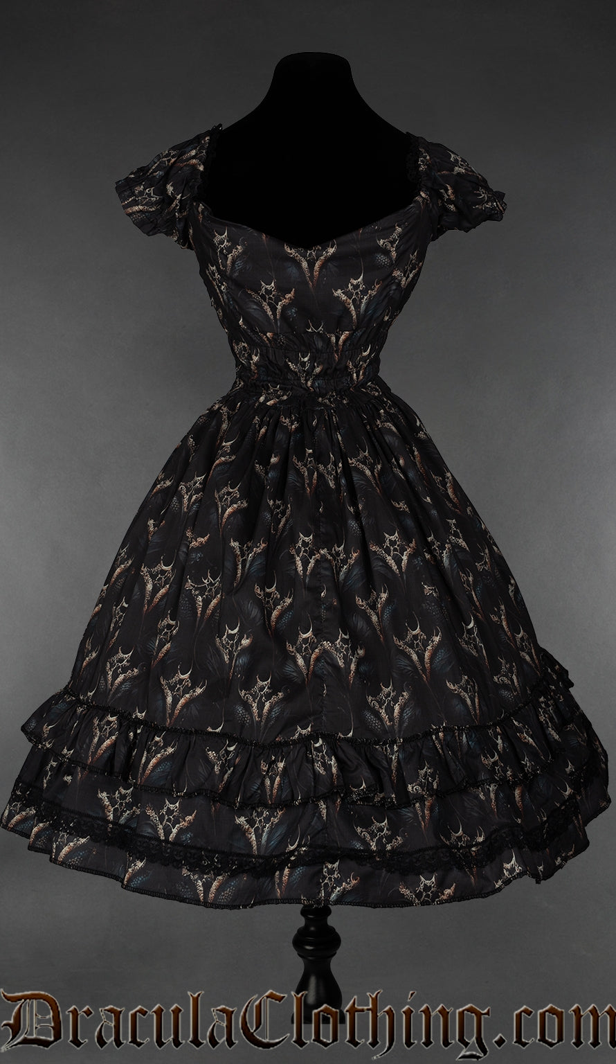 Back view of black women's dress with dragon print design showing very elasticated waist and black lace accents on skirt