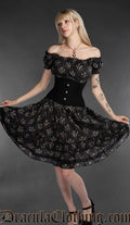 Women's knee length black dress with printed dragon design and stretchy bust and sleeves worn in an off shoulder style