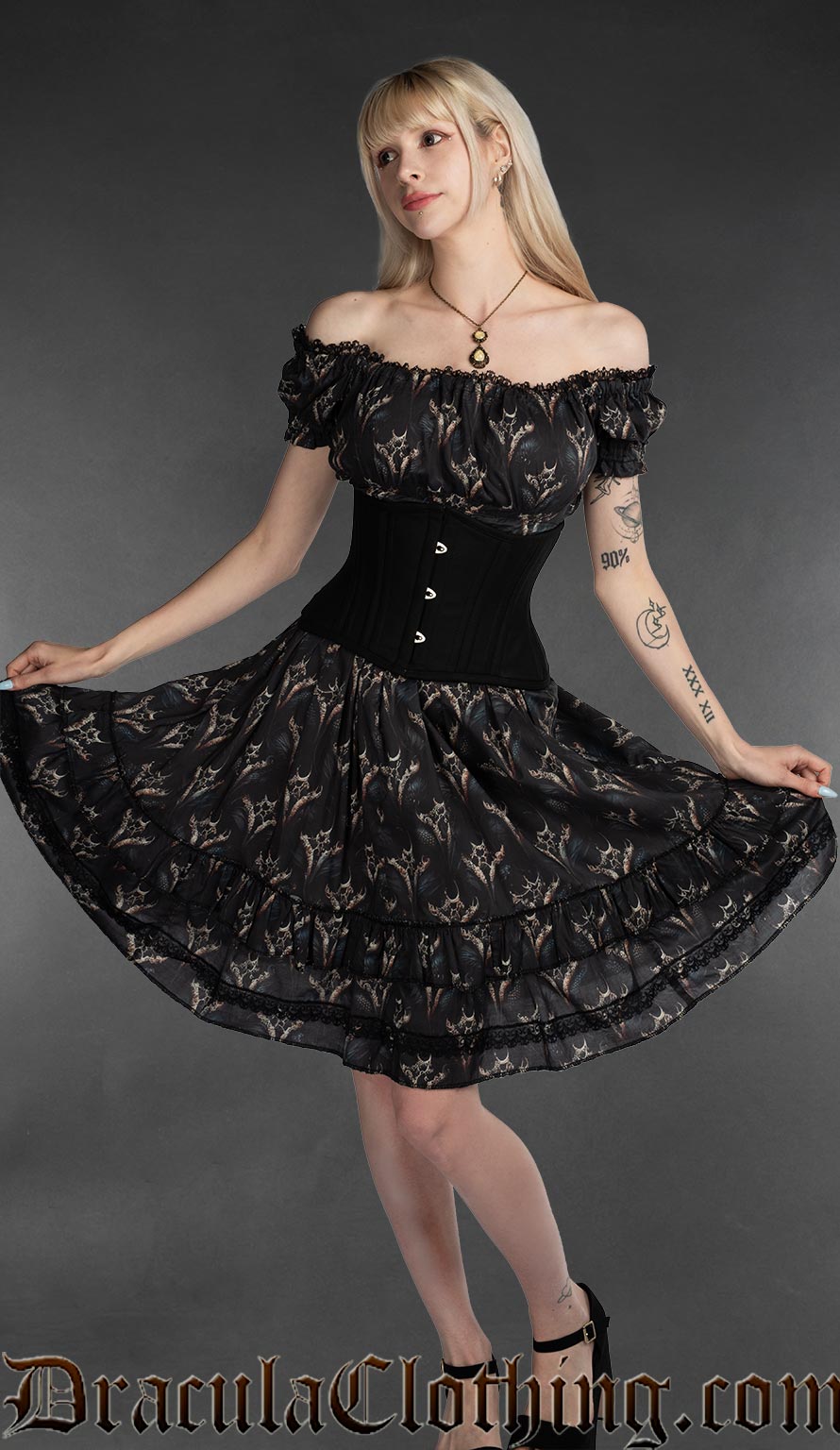 Women's knee length black dress with printed dragon design and stretchy bust and sleeves worn in an off shoulder style