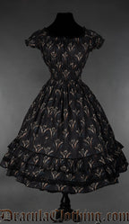 Knee length women's dress with elasticated waist bust and sleeves and featuring a printed dragon design