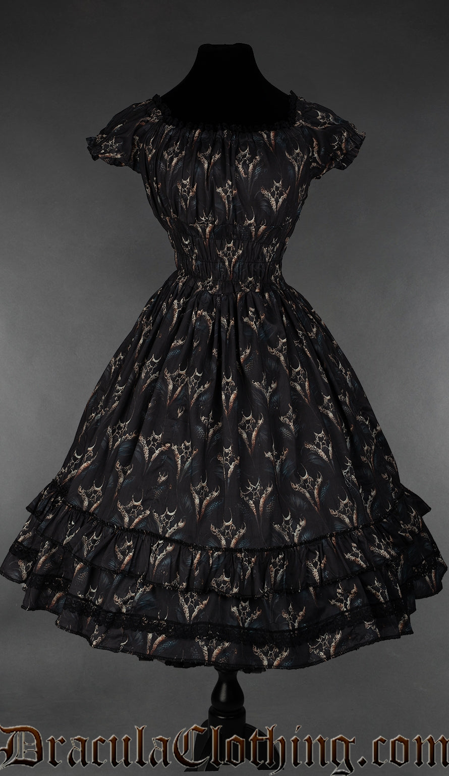 Knee length women's dress with elasticated waist bust and sleeves and featuring a printed dragon design
