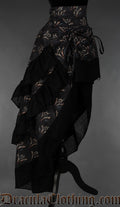 Side view of women's bustle skirt with three layers and dragon print design on black background
