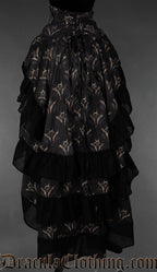 Back view of women's bustle skirt layered with printed dragon design and black cotton hem on each layer showing adjustable corset style lacing at the waist