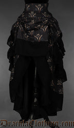Women's layered bustle skirt featuring a dragon print on a dark background shown with the skirt raised in the front