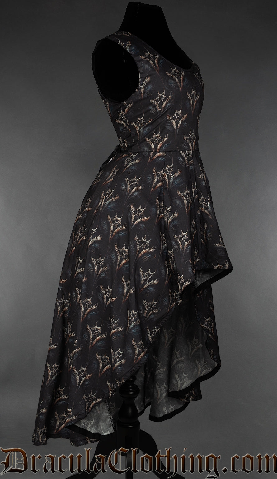 Side view of women's dress with printed dragon design showing high low style hem short in the front and long in the back
