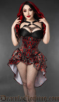 Model wearing red and black bustle corset with ornate skull print
