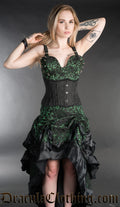 Model wearing green spiked vest top with matching fabric skirt and black waist cincher
