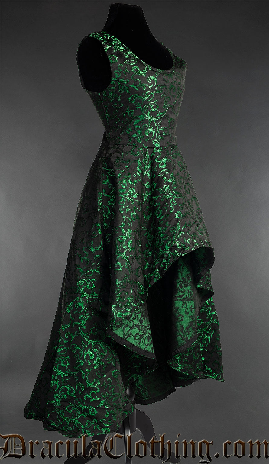 Side view of green and black women's brocade dress showing short skirt in the front and longer in the back