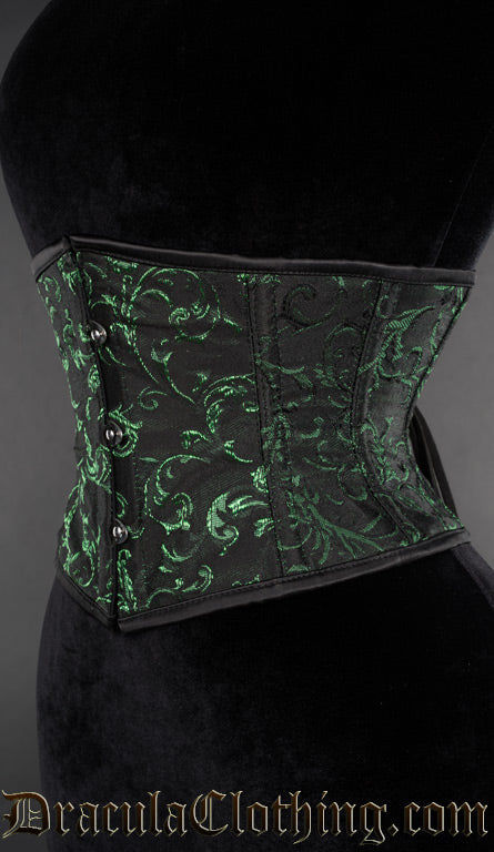 Side view of black waist cincher with woven green details in an emerald cotton brocade