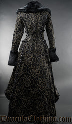Back view of women's winter coat in black and gold brocade jacquard fabric showing adjustable corset style lacing in the torso and long back length