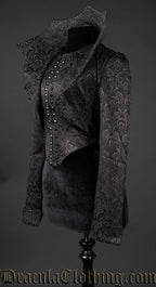 Side view of short black brocade women's jacket with dramatic collar shown standing up
