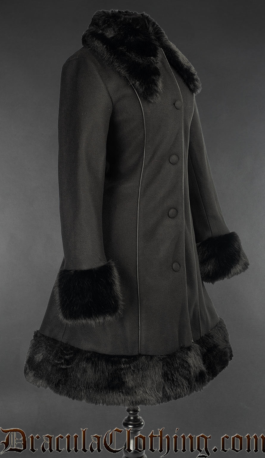 Side view of women's black knee length coat with black faux fur accents on collar cuffs adn hem