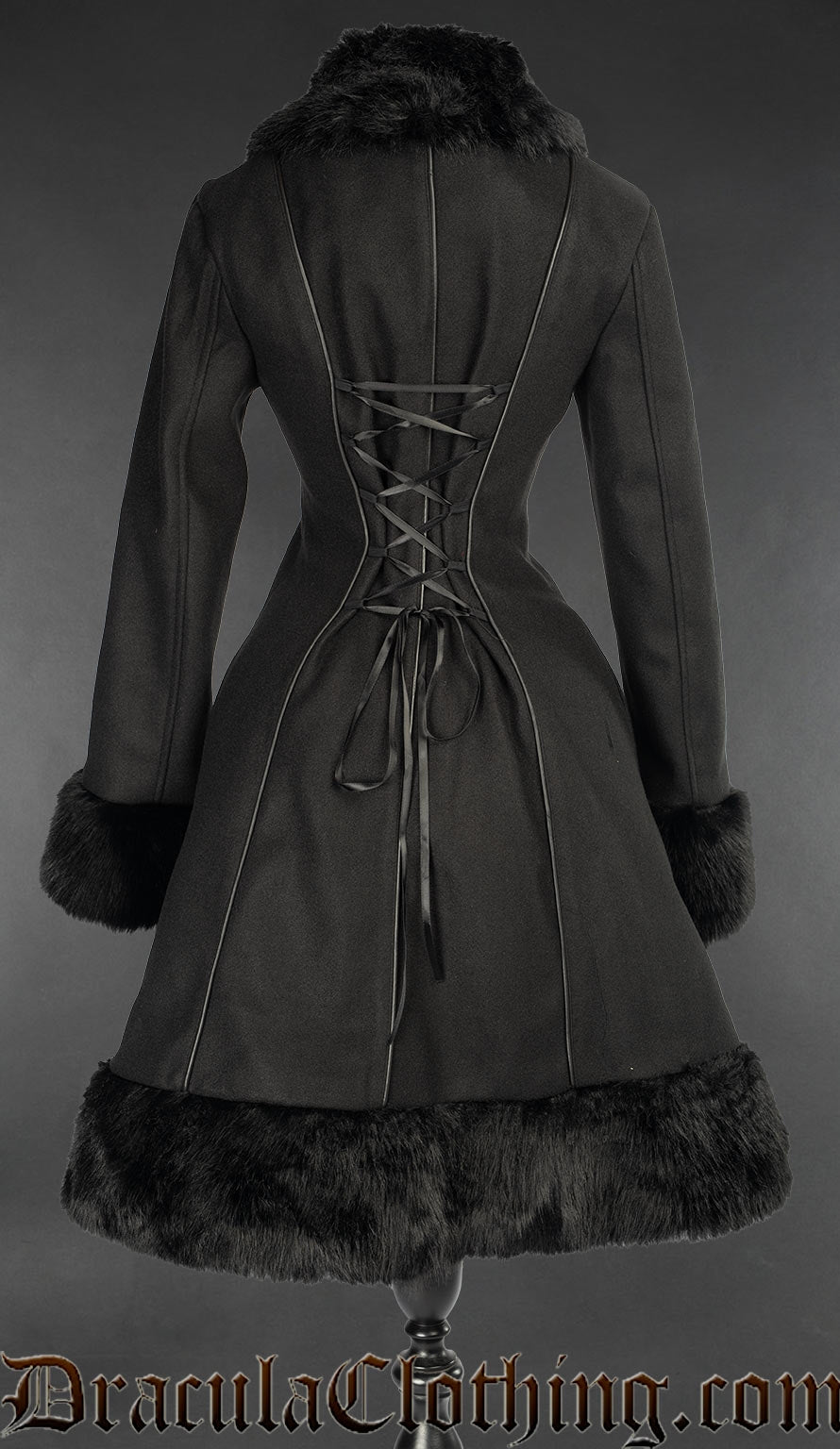 Back view of black women's coat with faux fur accents showing adjustable corset style lacing in the torso and additional piping detail in the back