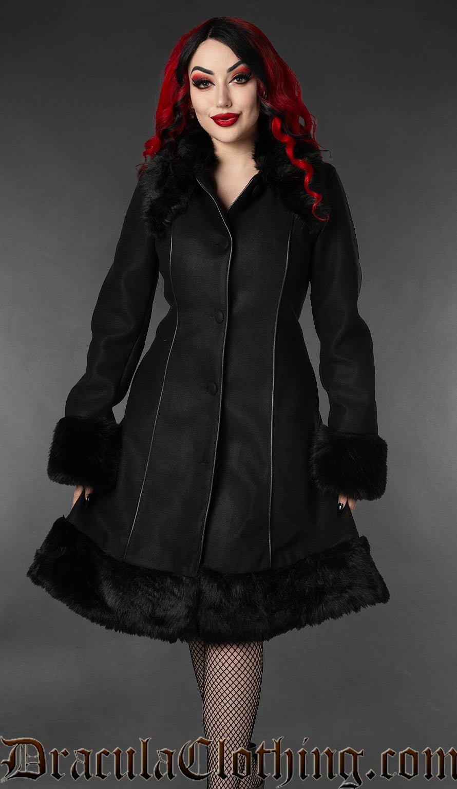 Women's knee length black coat with black faux fur accents and piping details