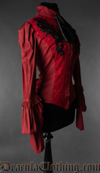 Side view of red floral women's blouse showing puffed shoulders and long sleeves with layers and fringe adornments