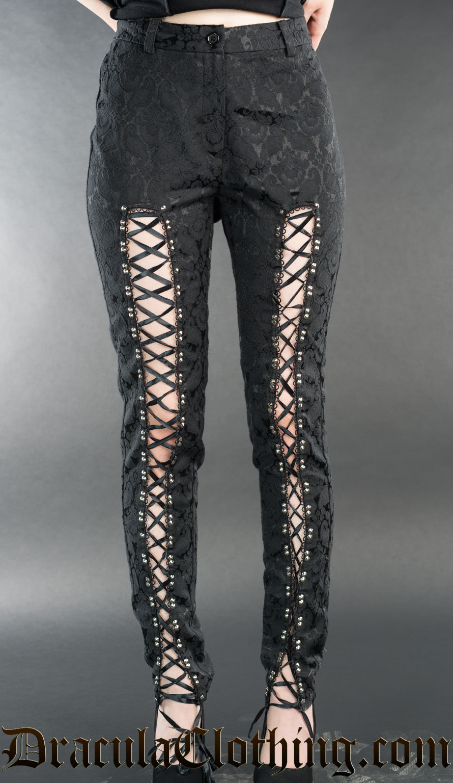Women's high waisted black cotton brocade pants with laced open panels in the front of the leg