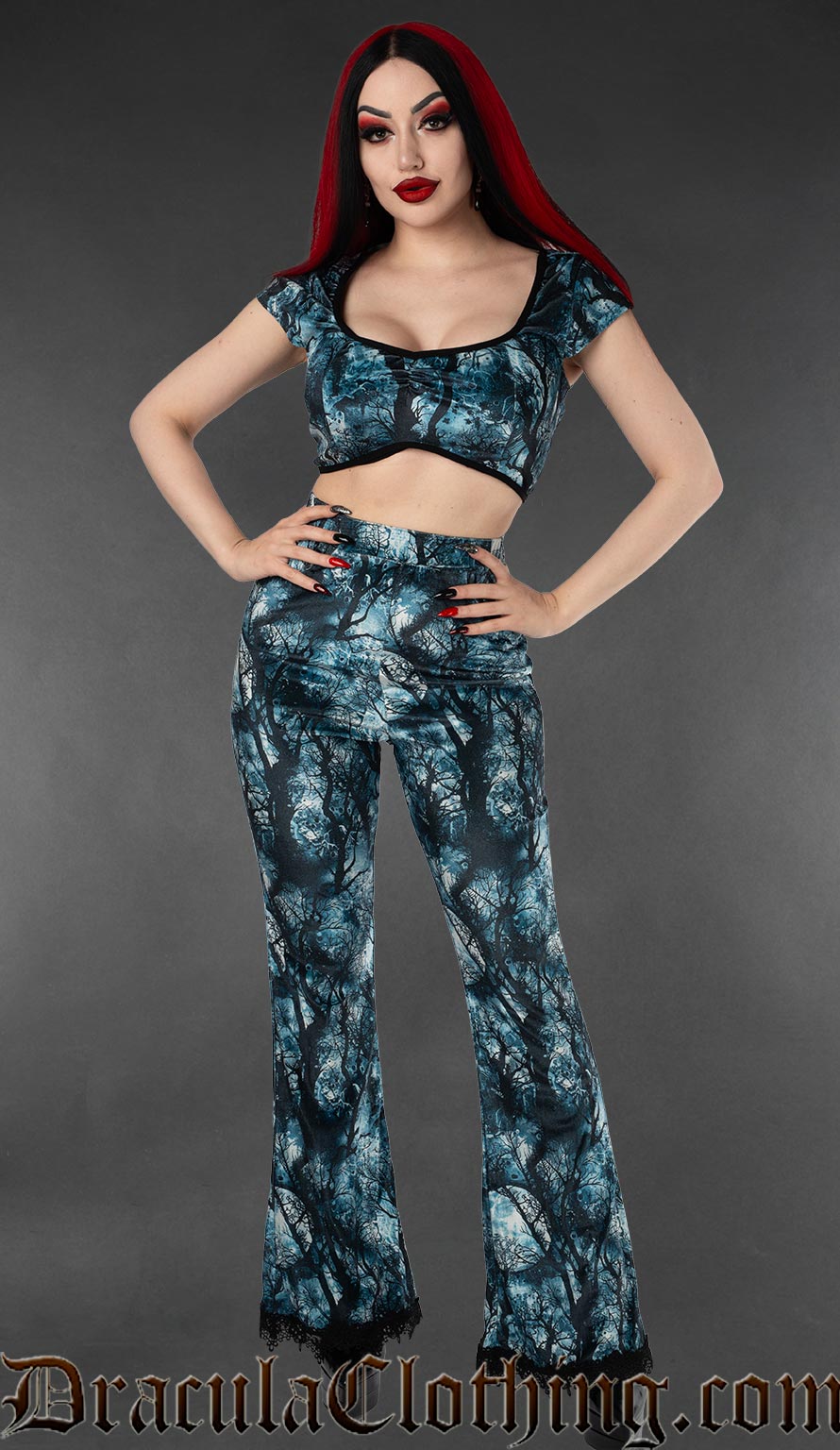 Women's high waisted flared velvet pants with moon and forest print in blue and black and with pockets