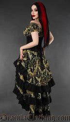 Black and gold cherub print layered bustle skirt and corset back worn by a model against a gray background