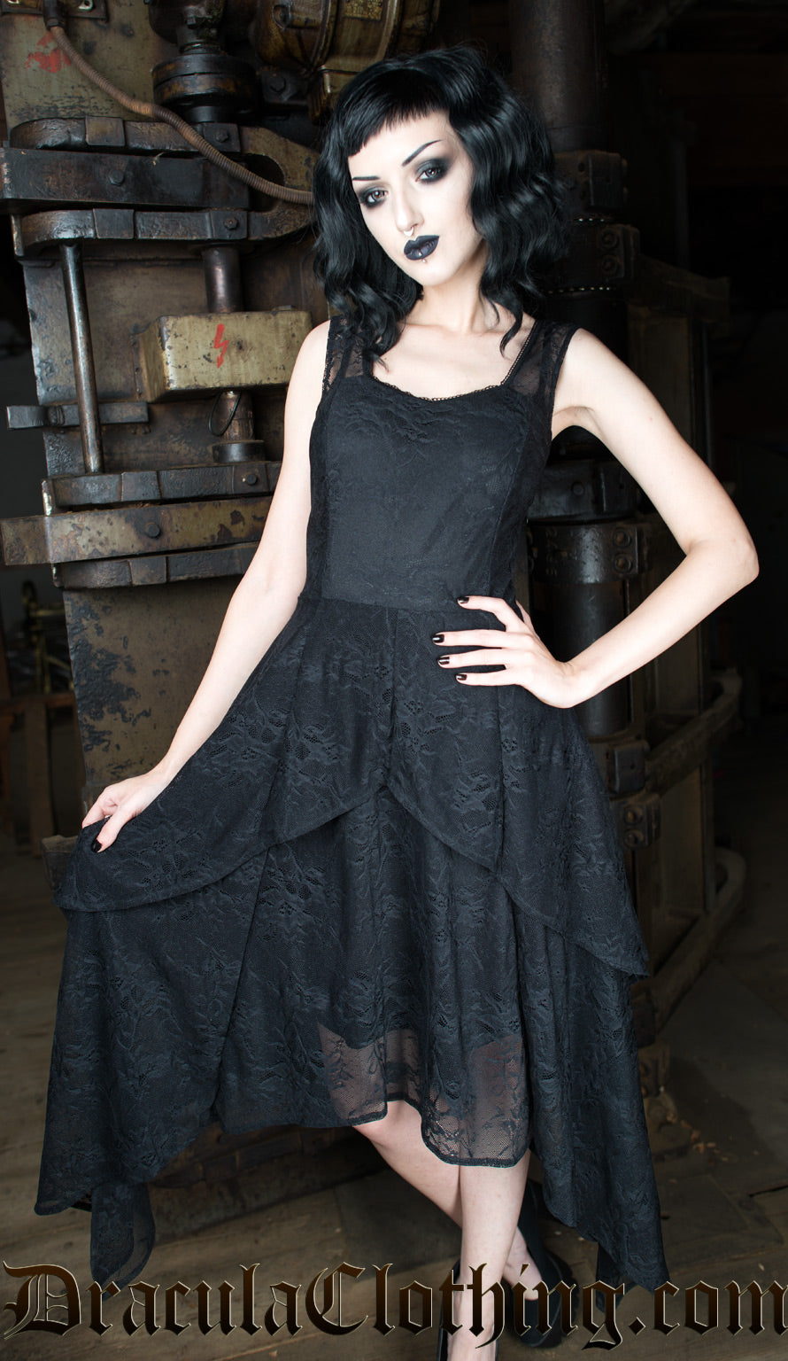 Model wearing black lace women's dress with layered lace handkerchief style skirt