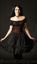 Black knee length women's dress with lace trim detail in the bust worn with the sleeves off shoulder