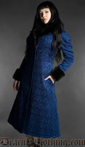 Blue gothic brocade coat with black faux fur trim cuffs and collar worn by model