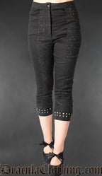 Women's skinny fit capris made with contrasting panels of plain black cotton and brocade fabric silver stud details on the cuffs