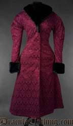 Front view of burgundy gothic brocade coat with black faux fur collar and cuffs on a gray background