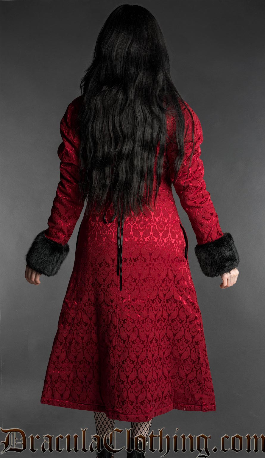 Woman modeling a red brocade gothic coat with black faux fur collar and cuffs, rear view