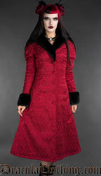 Red gothic brocade coat with black faux fur trim worn by a woman, front view