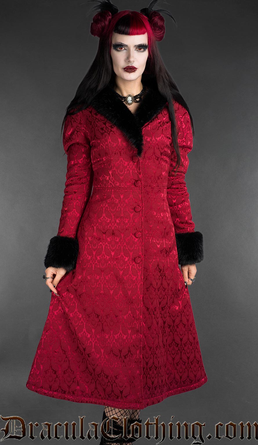 Red gothic brocade coat with black faux fur trim worn by a woman, front view