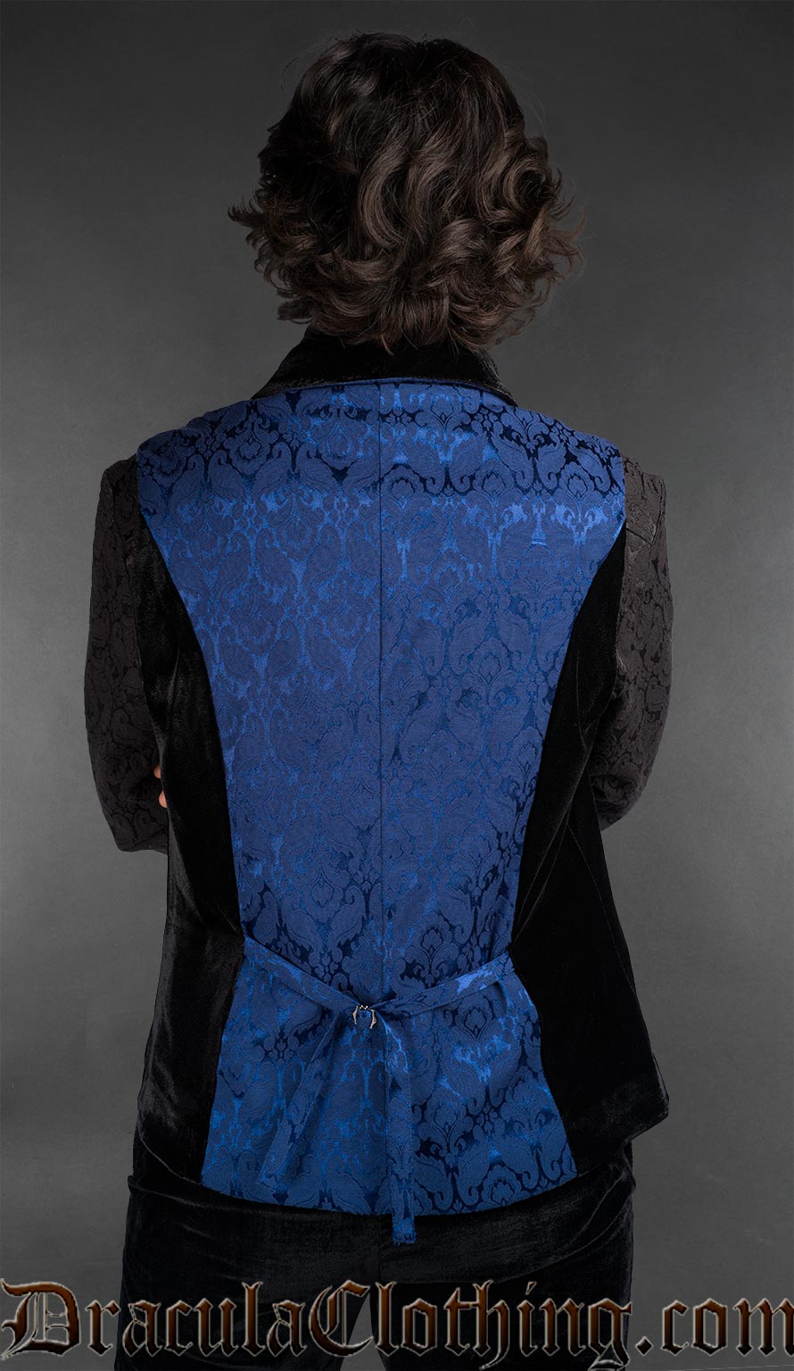 Back view of Men’s blue brocade gothic waistcoat with black shawl lapel, Victorian alternative vest worn over a black shirt